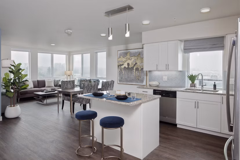 Modern kitchen with stainless steel appliances in Marvelle at Southcenter Apartments