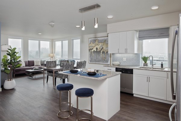 Modern kitchen with stainless steel appliances in Marvelle at Southcenter Apartments