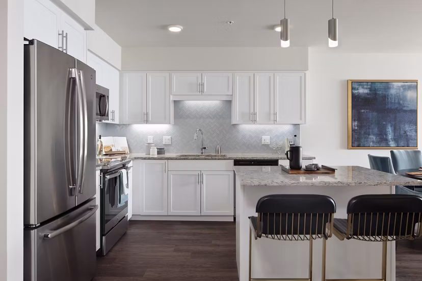 Modern kitchen featuring stainless steel appliances in Marvelle at Southcenter Apartments