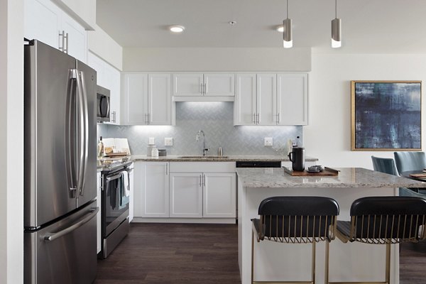 Modern kitchen featuring stainless steel appliances in Marvelle at Southcenter Apartments