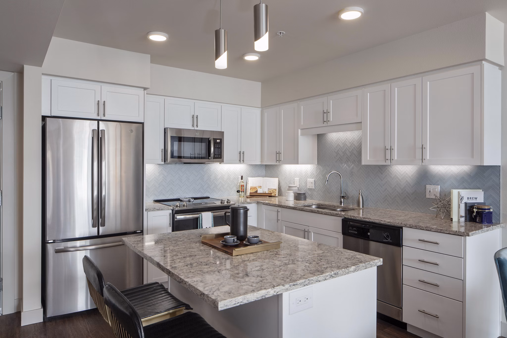Modern kitchen with sleek countertops and stainless steel appliances at Marvelle at Southcenter Apartments
