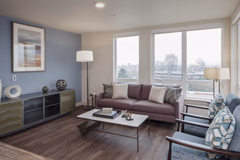 Bright living room with modern furnishings at Marvelle at Southcenter Apartments