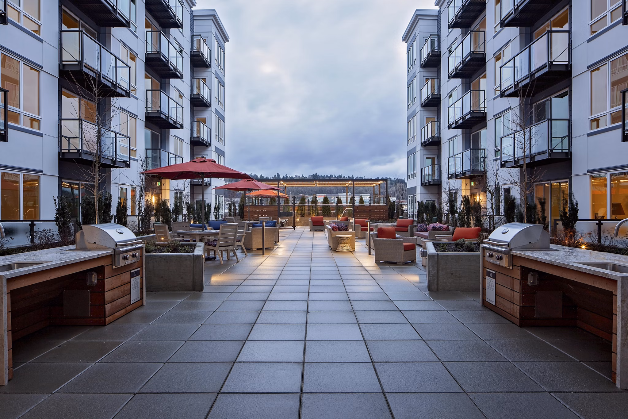 Outdoor grill area at Marvelle at Southcenter Apartments featuring modern BBQ stations and seating, perfect for entertaining and social gatherings
