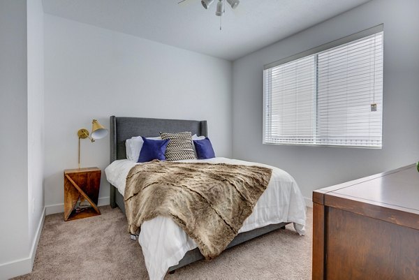 Cozy bedroom with modern decor at Brixton Apartments, a Greystar luxury property