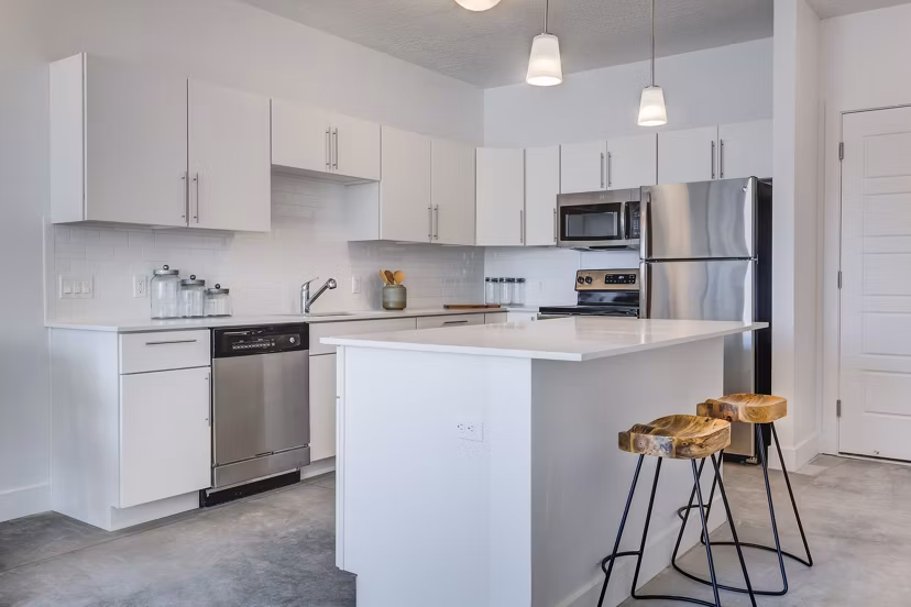 Modern kitchen with marble countertops and stainless steel appliances in Brixton Apartments, featuring a sleek design for stylish urban living