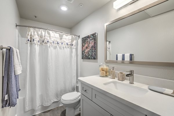 Large bathroom with modern fixtures and granite countertops at Ironwood North Apartments