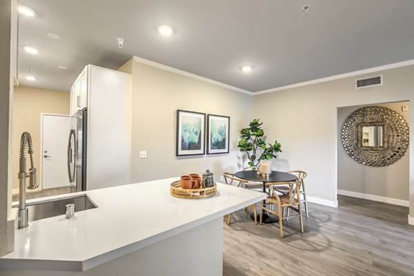 Ironwood North Apartments: Elegant dining area with wooden furniture and modern lighting