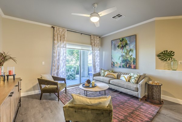 Modern living room with sleek furniture and large windows at Ironwood North Apartments, offering luxurious living spaces in a prime location