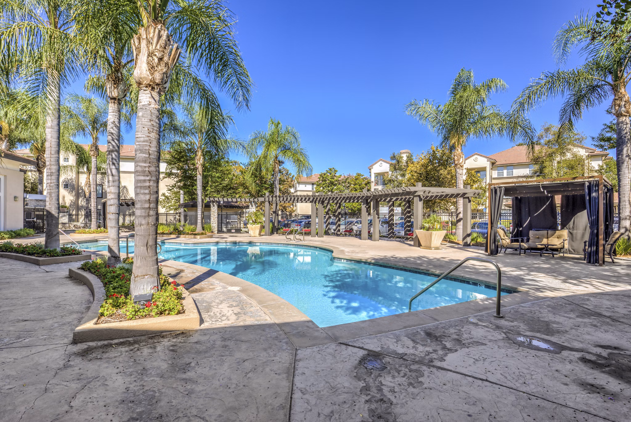 Resort-style pool with lounge chairs at Ironwood North Apartments