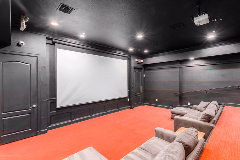 Theater room with plush seating and a large screen at Artessa Apartments
