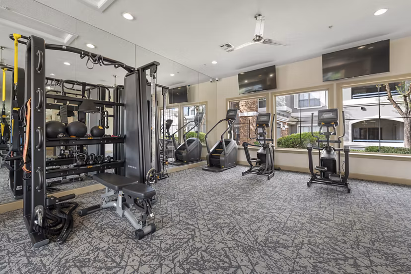 Fitness center with modern equipment at Artessa Apartments