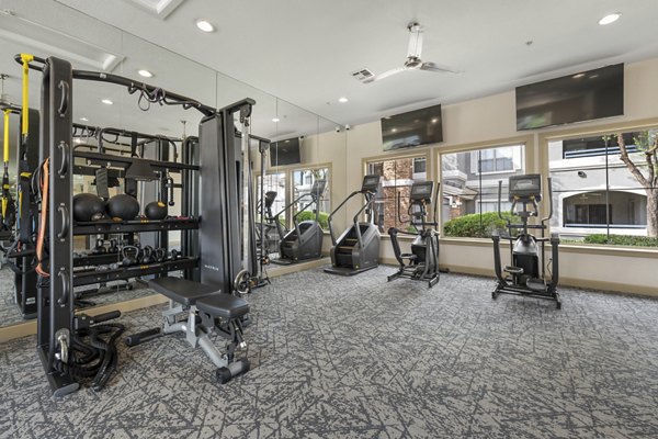 Fitness center with modern equipment at Artessa Apartments