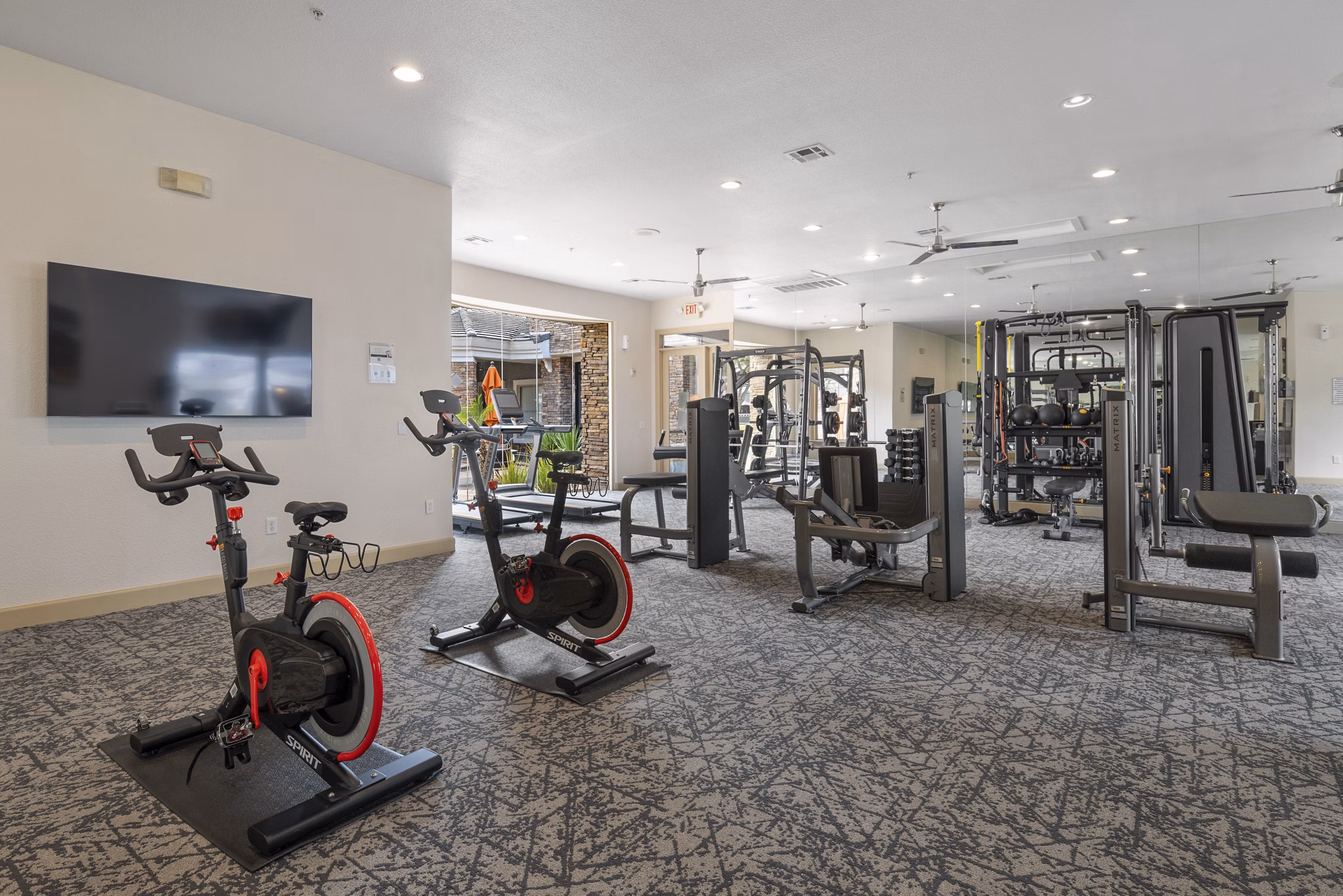 Modern fitness center with cardio and weight equipment at Artessa Apartments