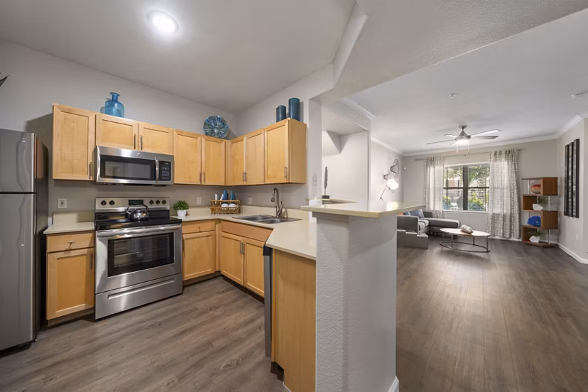 Artessa Apartments: Modern kitchen with stainless steel appliances and granite countertops in luxury apartment