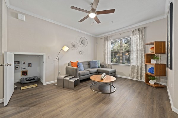 Spacious living room with modern dÃ©cor and natural light at Artessa Apartments