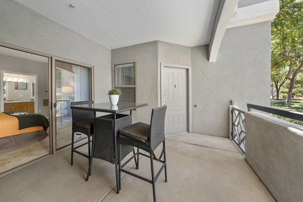 Patio with modern seating and lush greenery at Artessa Apartments luxury rentals