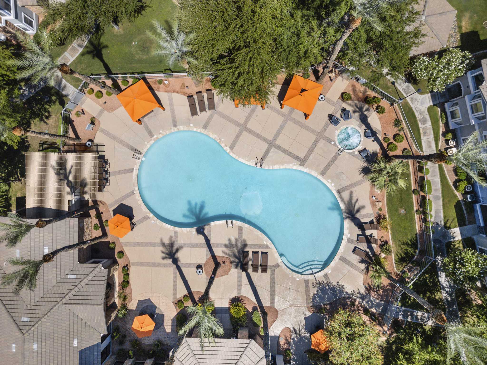 Sparkling outdoor pool with lounge chairs at Artessa Apartments, offering luxury relaxation amenities