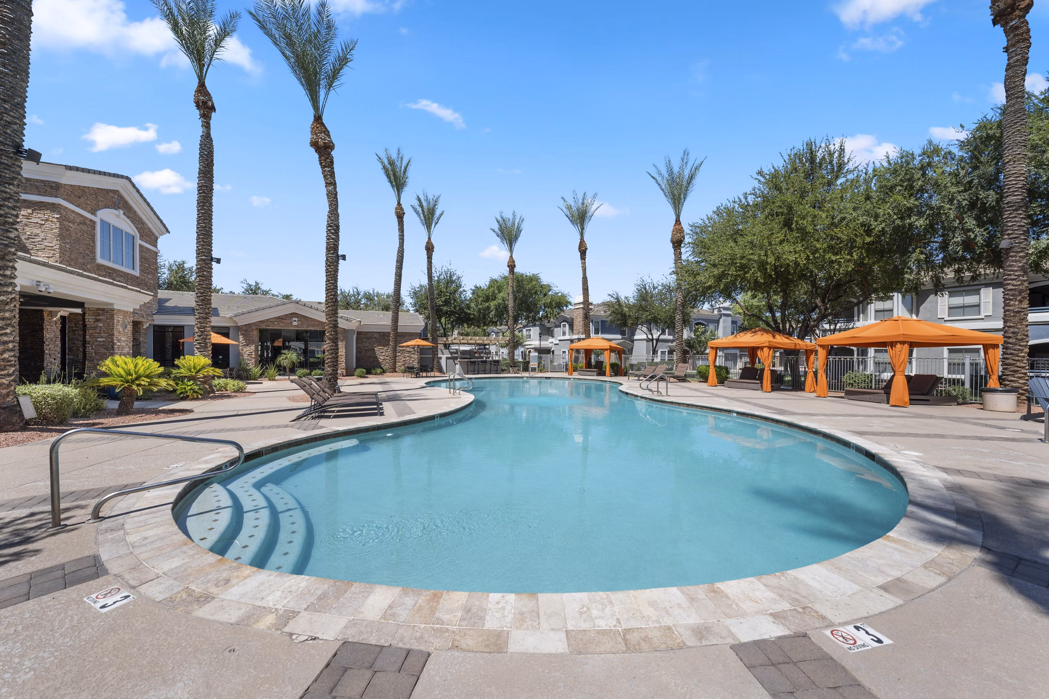 Artessa Apartments: Luxurious pool area with loungers and lush landscaping in our vibrant luxury apartment community