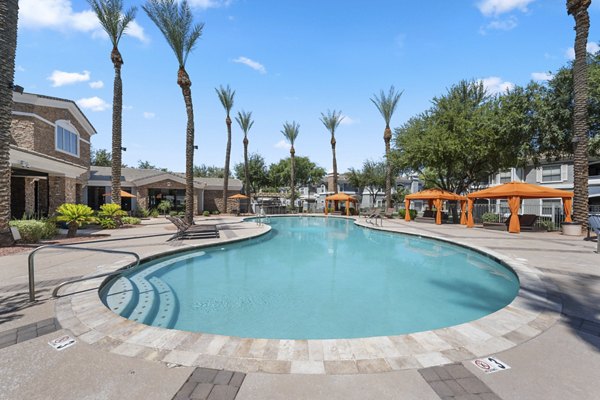 Artessa Apartments: Luxurious pool area with loungers and lush landscaping in our vibrant luxury apartment community