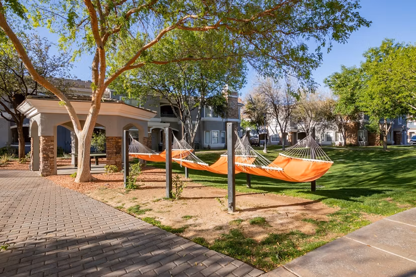 Tranquil courtyard with seating and lush greenery at Artessa Apartments, perfect for relaxation and socializing