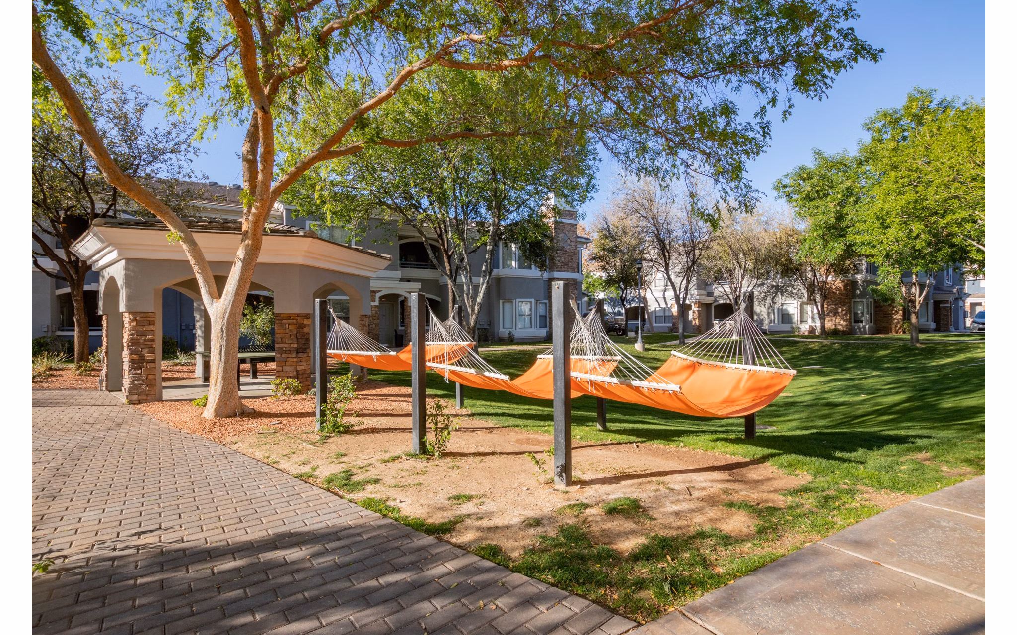 Tranquil courtyard with seating and lush greenery at Artessa Apartments, perfect for relaxation and socializing