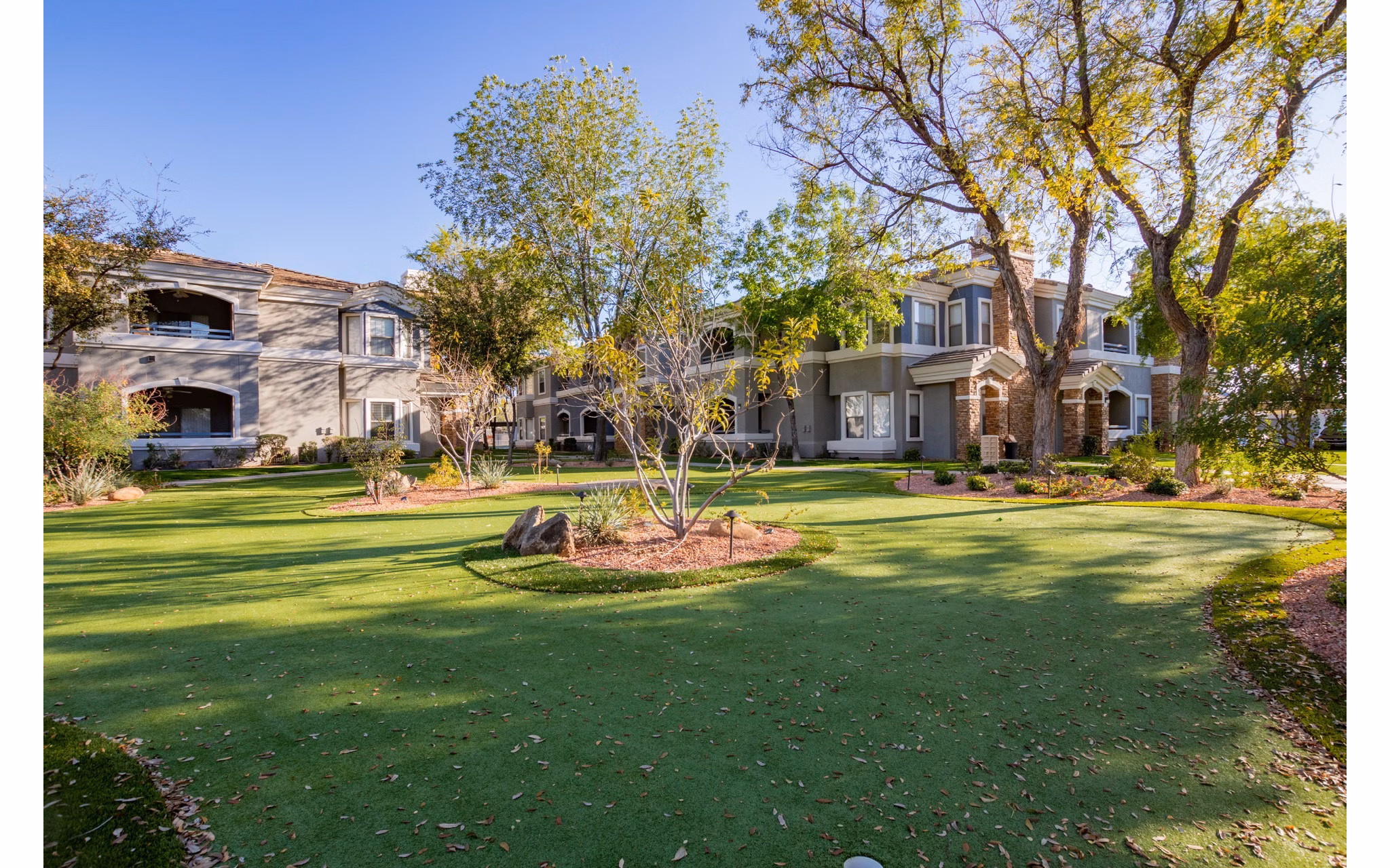 Tranquil courtyard with seating and lush greenery at Artessa Apartments luxury apartments