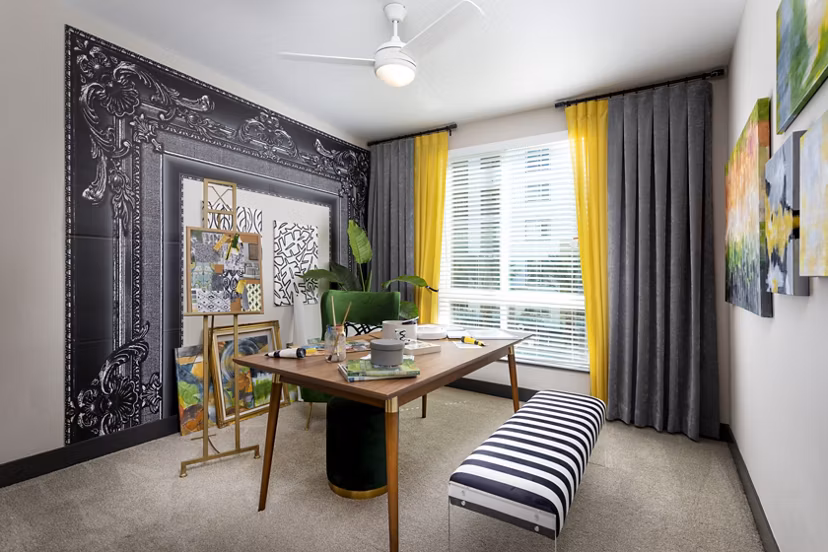 Den featuring modern decor and ample seating at Jefferson Rise Apartments, a Greystar luxury property
