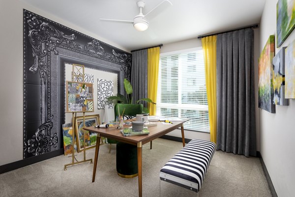 Den featuring modern decor and ample seating at Jefferson Rise Apartments, a Greystar luxury property