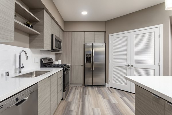 Modern kitchen with stainless steel appliances at Jefferson Rise Apartments