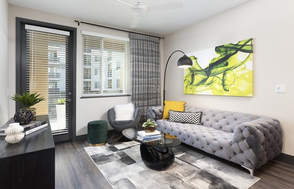 Modern living room with designer furnishings and natural light at Jefferson Rise Apartments