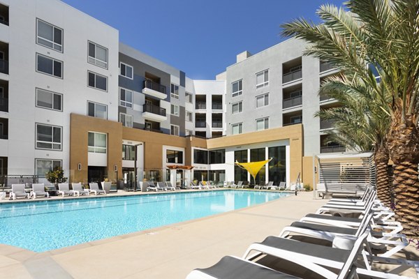 Luxury pool with lounge chairs at Jefferson Rise Apartments, featuring stunning views and modern design for ultimate relaxation