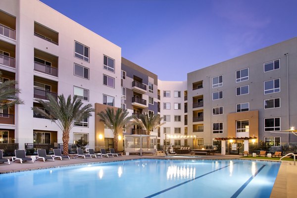 Luxurious pool area with lounge chairs at Jefferson Rise Apartments