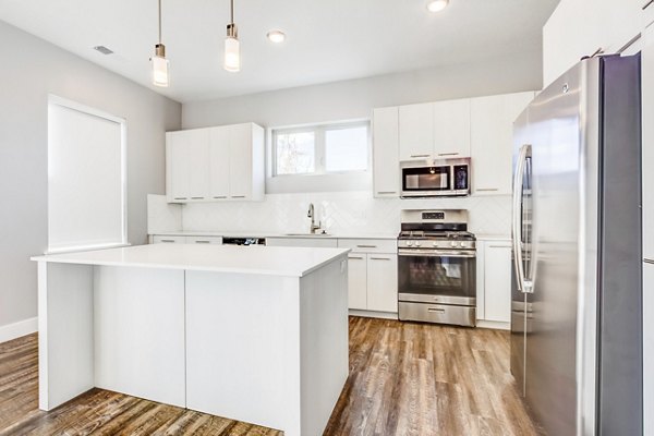 Modern kitchen with stainless steel appliances and granite countertops at Park East Apartments
