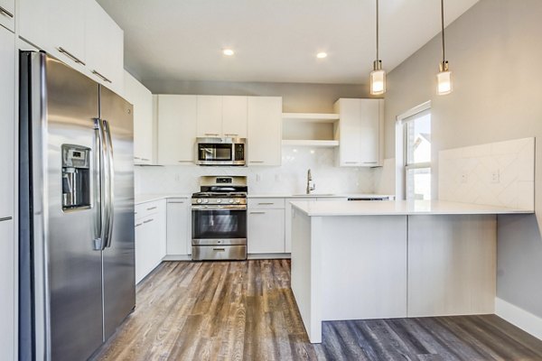 Modern kitchen with stainless steel appliances at Park East Apartments, featuring elegant countertops and ample storage space