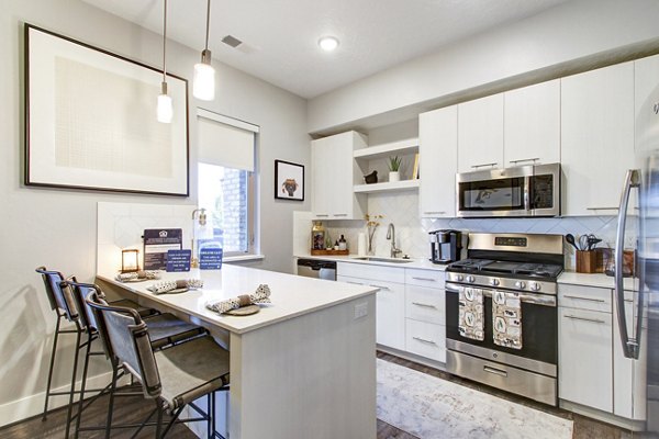Modern kitchen with stainless steel appliances in Park East Apartments