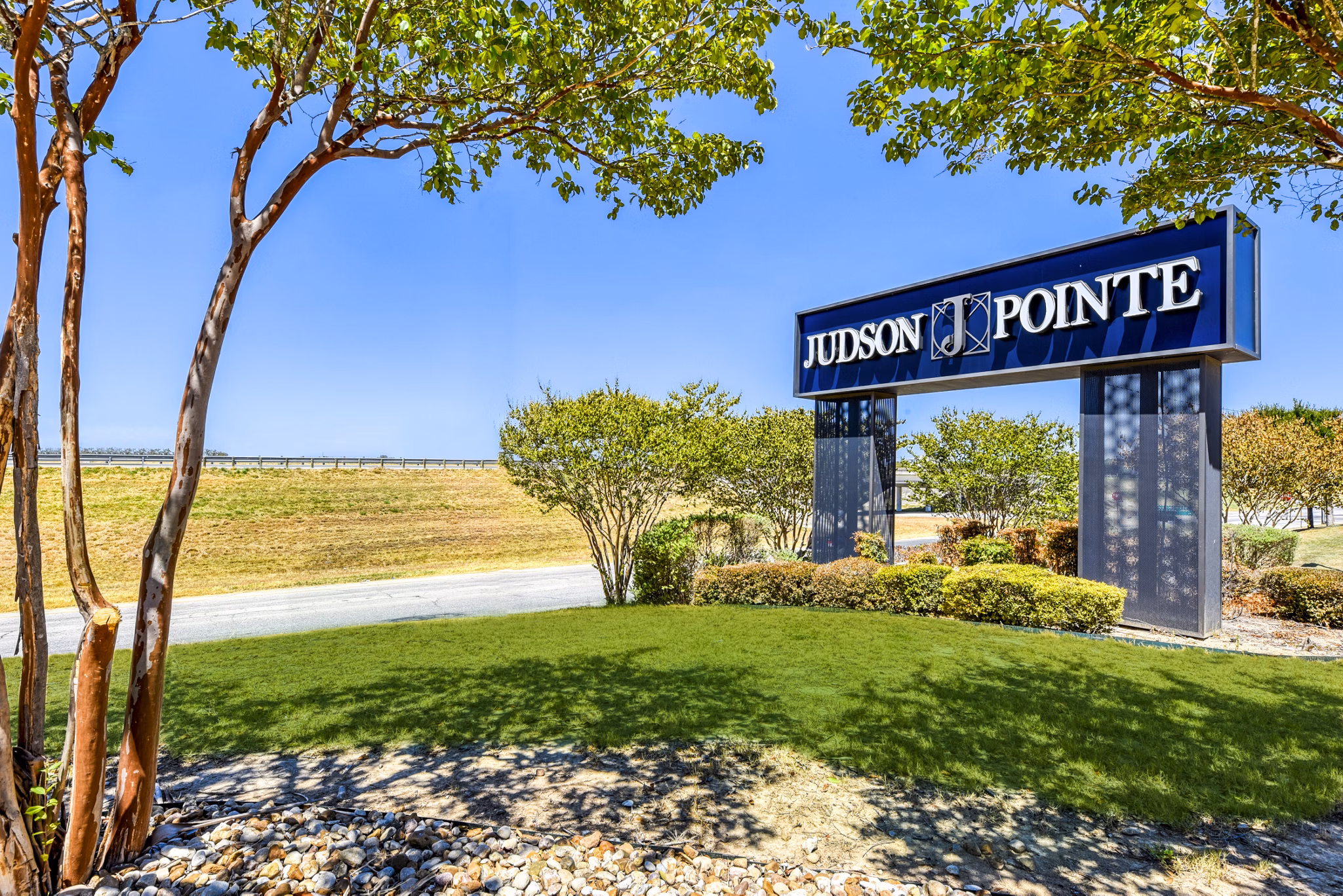 Judson Pointe Apartments signage highlighting luxury amenities in a vibrant community setting