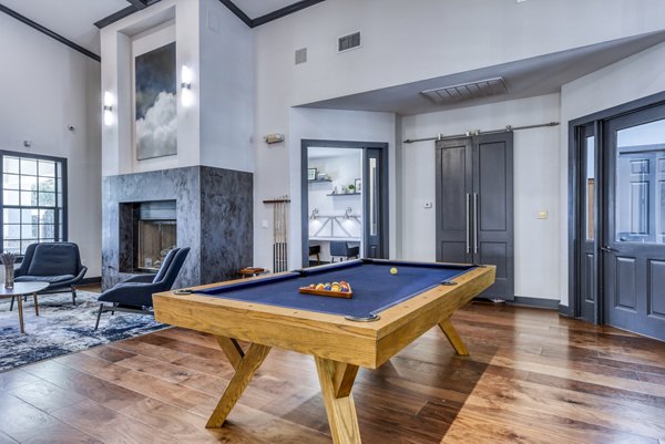Clubhouse game room featuring modern decor and pool table at Judson Pointe Apartments
