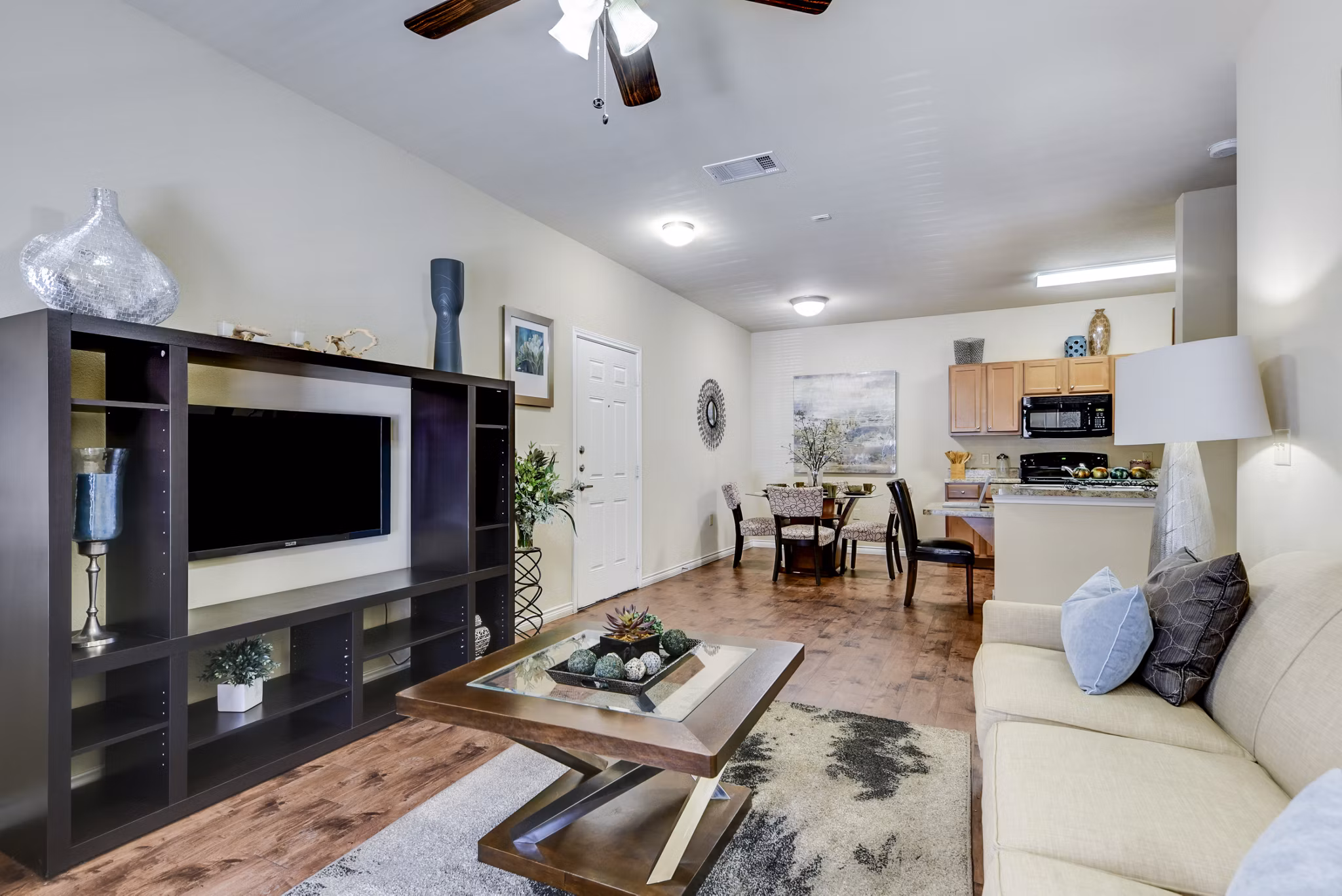 Spacious living room with contemporary decor and large windows in Judson Pointe Apartments