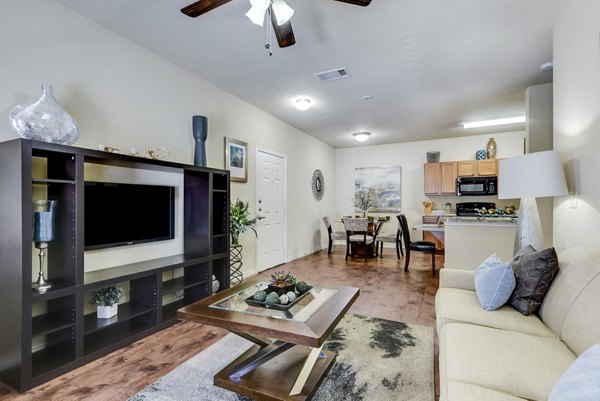 Spacious living room with contemporary decor and large windows in Judson Pointe Apartments