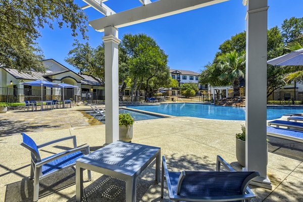 Modern pool with sun loungers on the patio at Judson Pointe Apartments, ideal for relaxation and socializing