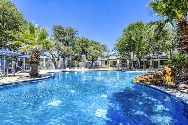 Modern outdoor pool with surrounding sun loungers at Judson Pointe Apartments luxury rentals