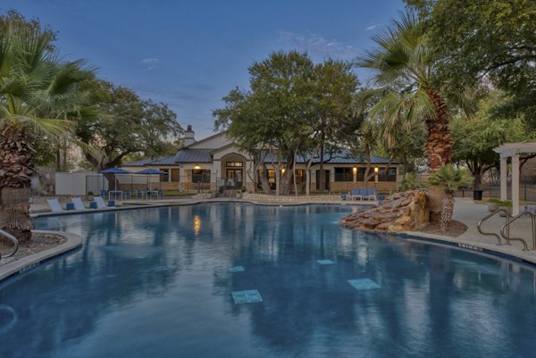 Rooftop pool surrounded by lush greenery at Judson Pointe Apartments