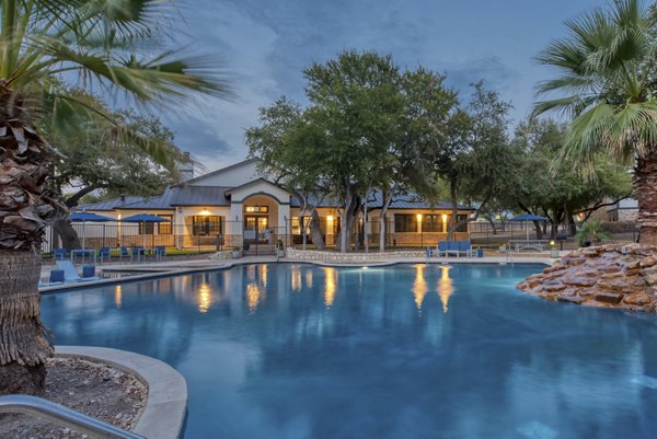 Relaxing pool at Judson Pointe Apartments with surrounding lounge chairs and landscaping