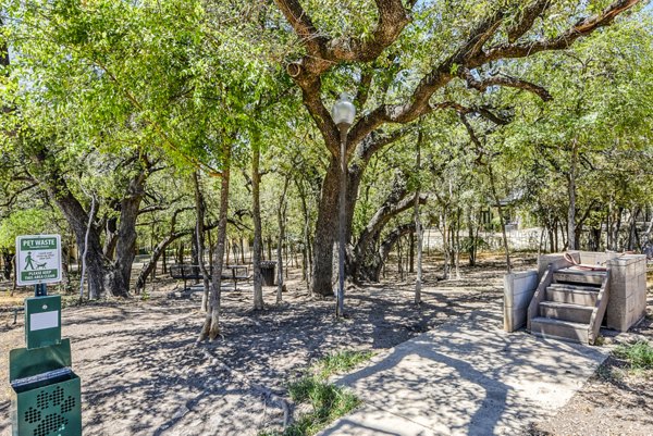 Dog-friendly park for pets at Judson Pointe Town Centre Apartments, featuring agility equipment and open green space for resident enjoyment