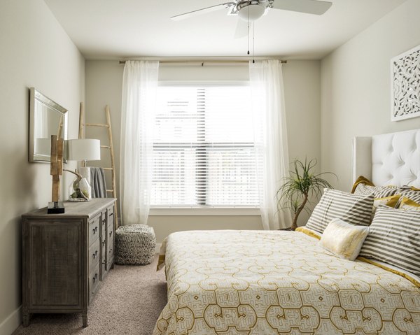 Bedroom with modern decor and ambient lighting at Stella at Riverstone Apartments luxury units