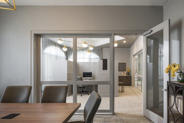 Meeting facility with modern seating and projectors at Stella at Riverstone Apartments, designed for productive gatherings and events