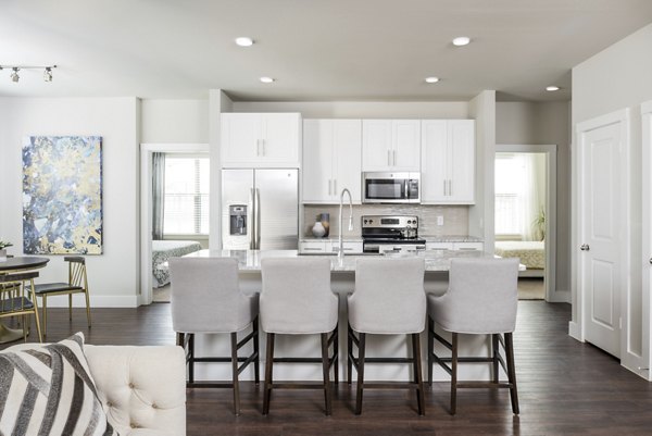 Modern kitchen with stainless steel appliances in Stella at Riverstone Apartments