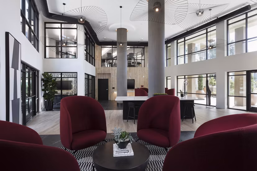 Stylish clubhouse bar with modern decor at Revela Apartments, perfect for social gatherings and relaxation