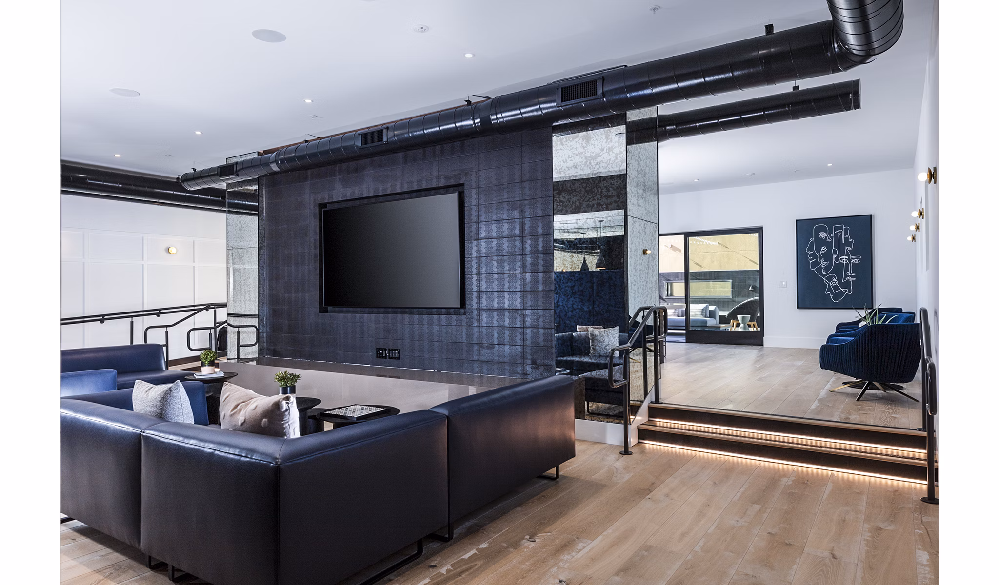 Modern theater with plush seating and advanced AV technology at Revela Apartments