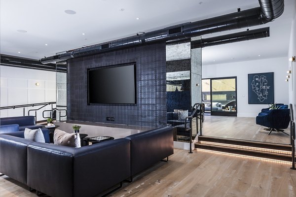 Modern theater with plush seating and advanced AV technology at Revela Apartments